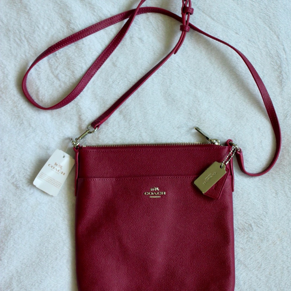 Coach Pink Crossbody Bag with Sleek Design and Adjustable Strap